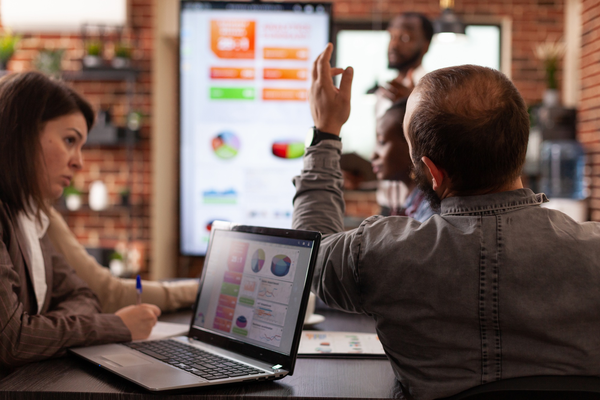 Businesspeople working at management project analyzing company graph