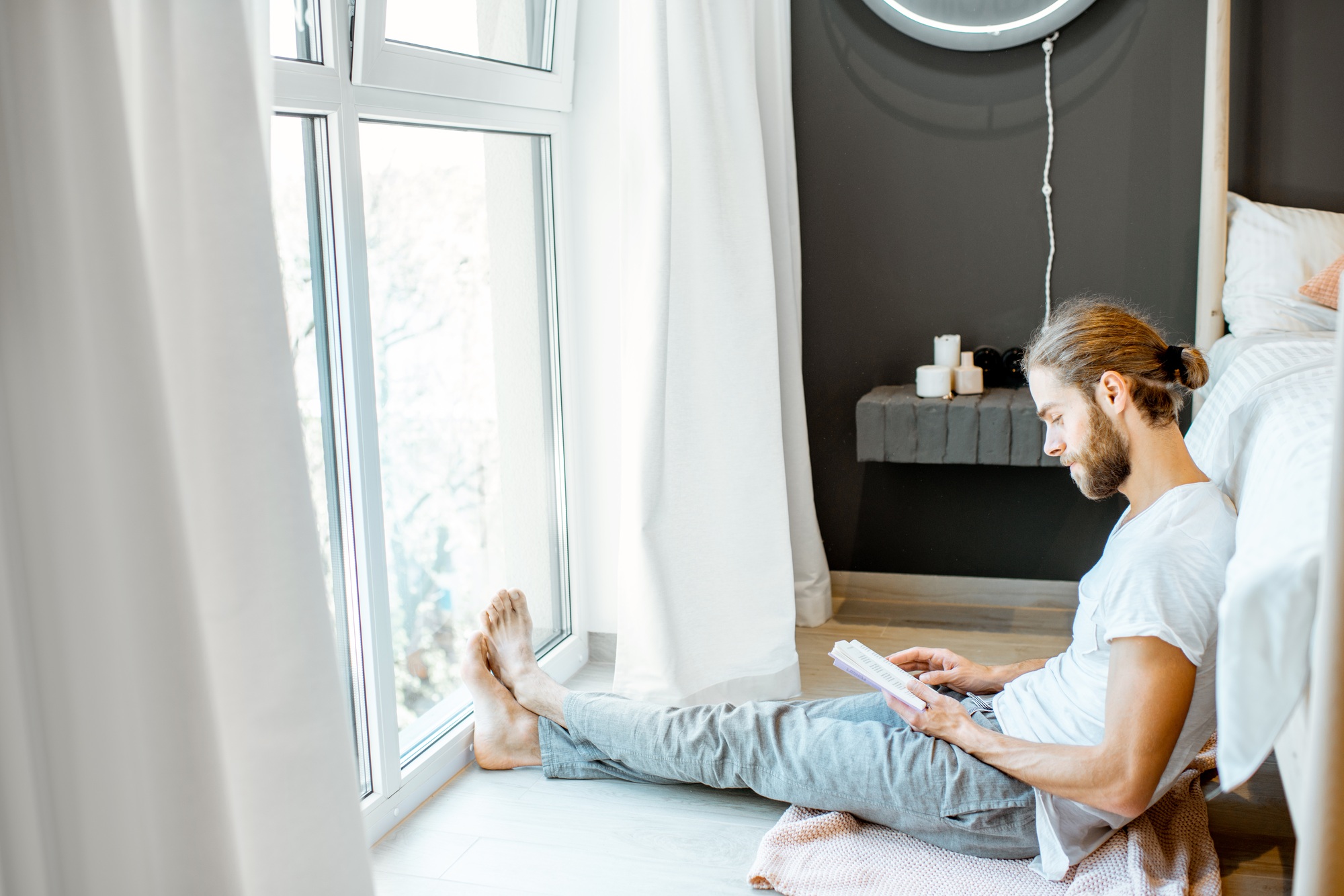 Man reading book in the bedroom