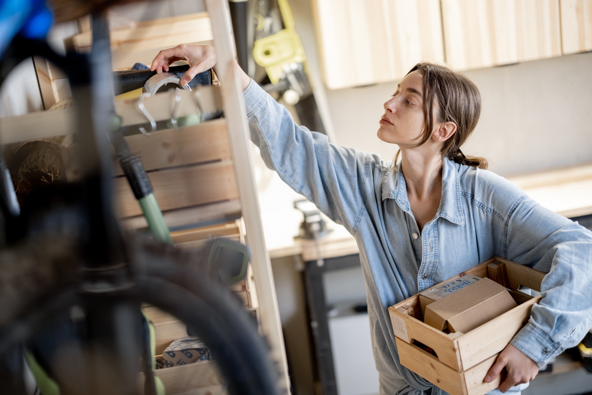 Woman searching some tools in the workshop